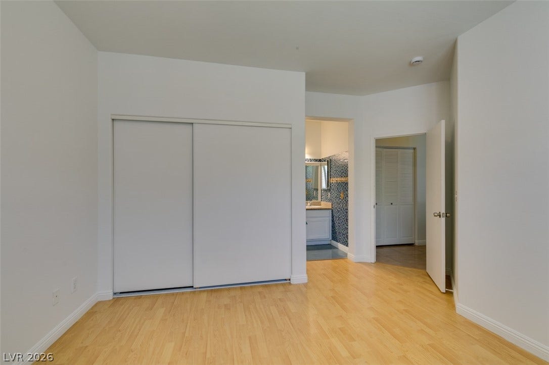 10513 Shanna Trellis Avenue, Las Vegas, NV 89144 Unfurnished bedroom featuring light wood-style flooring, a closet, and ensuite bath