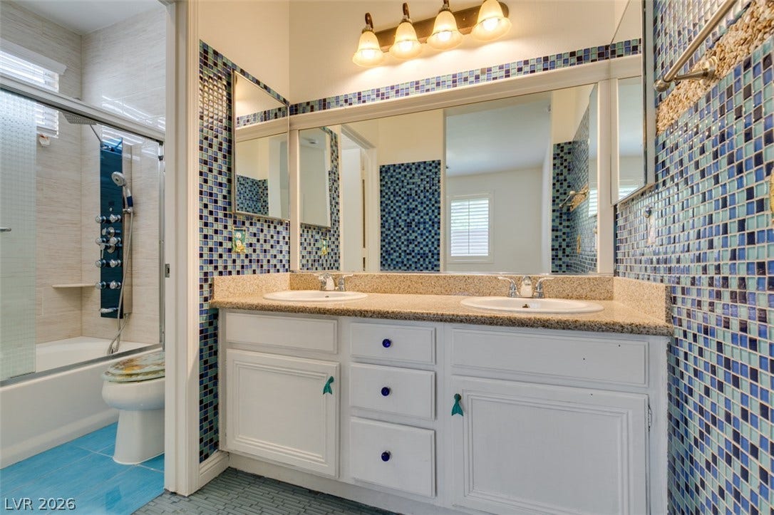 10513 Shanna Trellis Avenue, Las Vegas, NV 89144 Bathroom with tile walls, double vanity, enclosed tub / shower combo, and tile patterned flooring