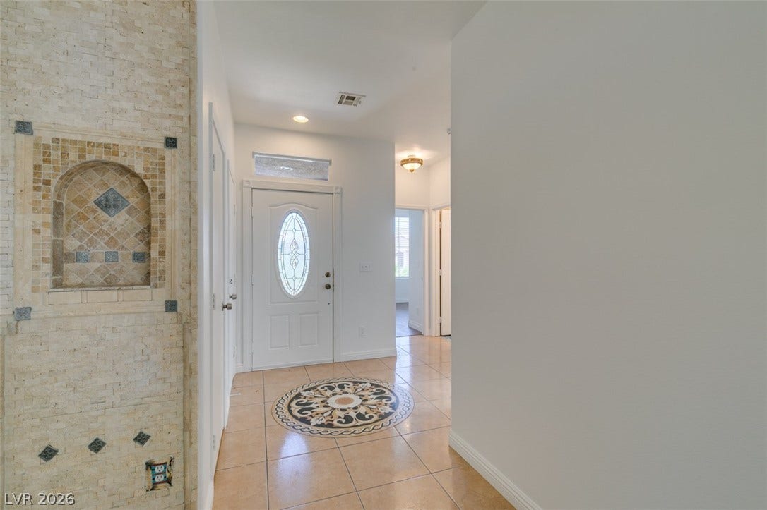 10513 Shanna Trellis Avenue, Las Vegas, NV 89144 Entryway with light tile patterned flooring and baseboards