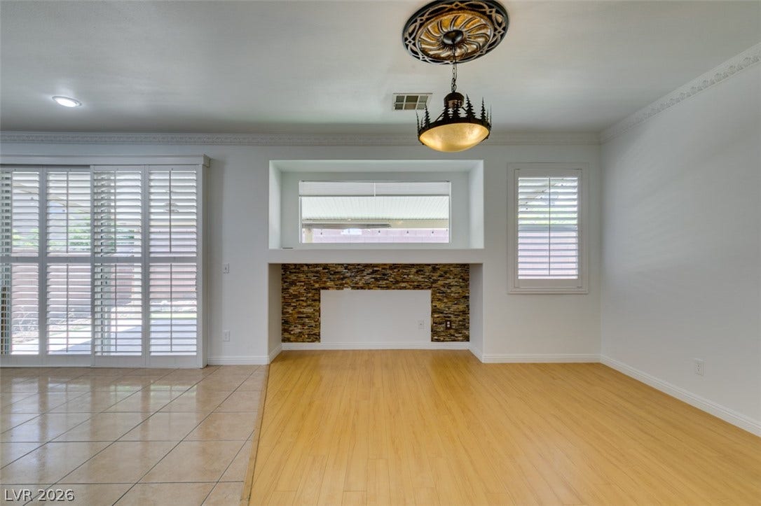 10513 Shanna Trellis Avenue, Las Vegas, NV 89144 Unfurnished living room with light wood-style floors and ornamental molding
