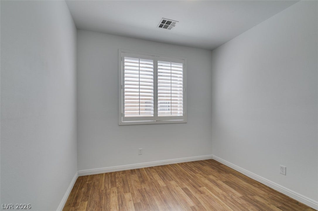 10513 Shanna Trellis Avenue, Las Vegas, NV 89144 Spare room with baseboards and light wood-style flooring