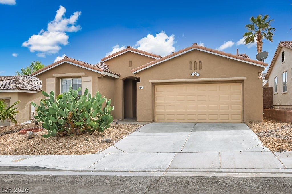 10513 Shanna Trellis Avenue, Las Vegas, NV 89144 Mediterranean / spanish home featuring stucco siding, a tile roof, a garage, and concrete driveway