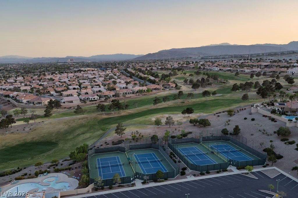 10513 Shanna Trellis Avenue, Las Vegas, NV 89144 Aerial view at dusk of golf course view, a mountain view, and a residential view