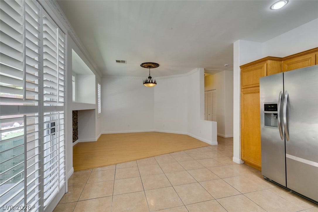10513 Shanna Trellis Avenue, Las Vegas, NV 89144 Kitchen featuring stainless steel refrigerator with ice dispenser, light tile patterned floors, ornamental molding, and pendant lighting