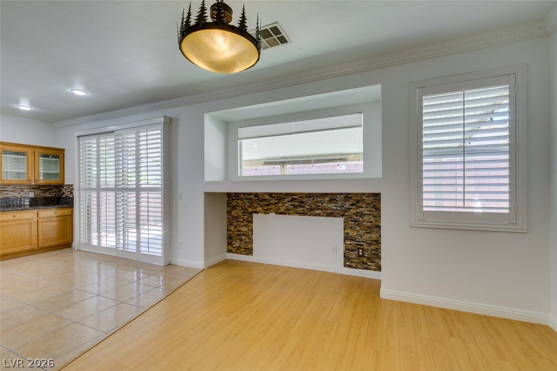 10513 Shanna Trellis Avenue, Las Vegas, NV 89144 Unfurnished living room featuring crown molding and light wood-type flooring