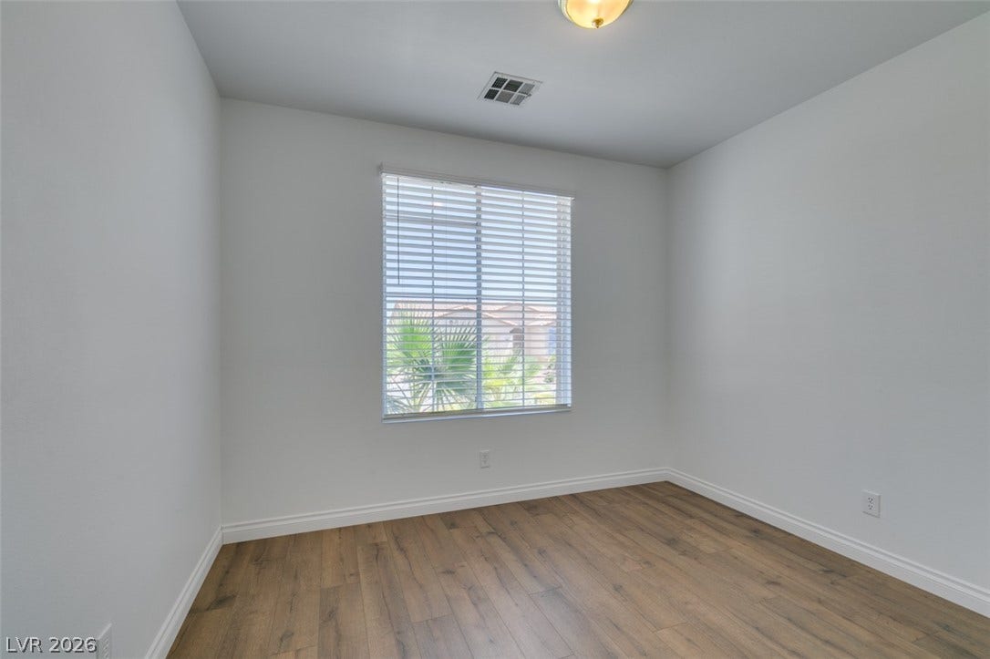 10513 Shanna Trellis Avenue, Las Vegas, NV 89144 Empty room with baseboards and wood finished floors