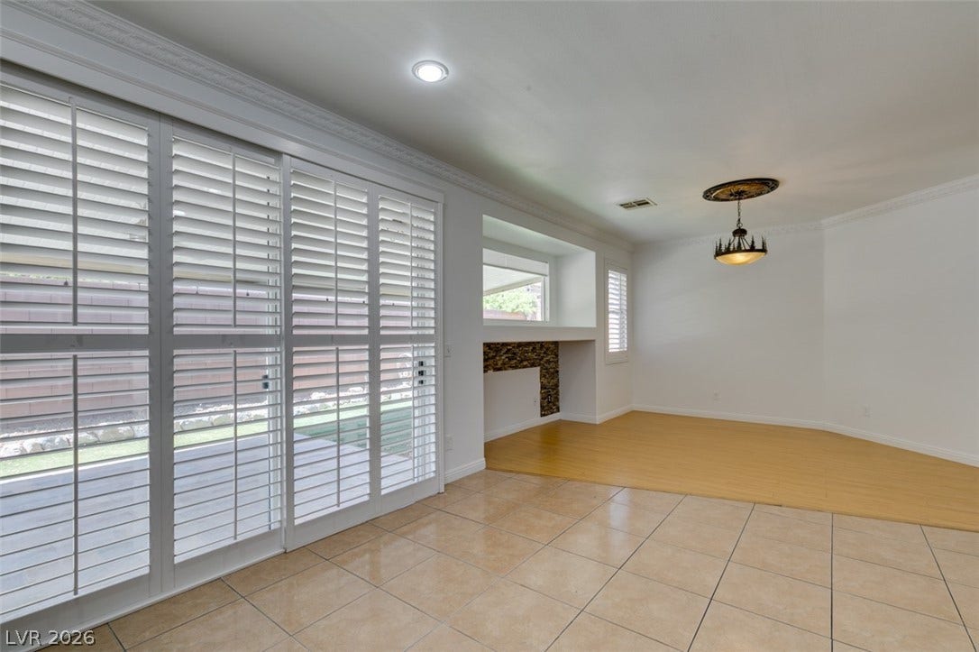 10513 Shanna Trellis Avenue, Las Vegas, NV 89144 Empty room featuring crown molding and light tile patterned floors