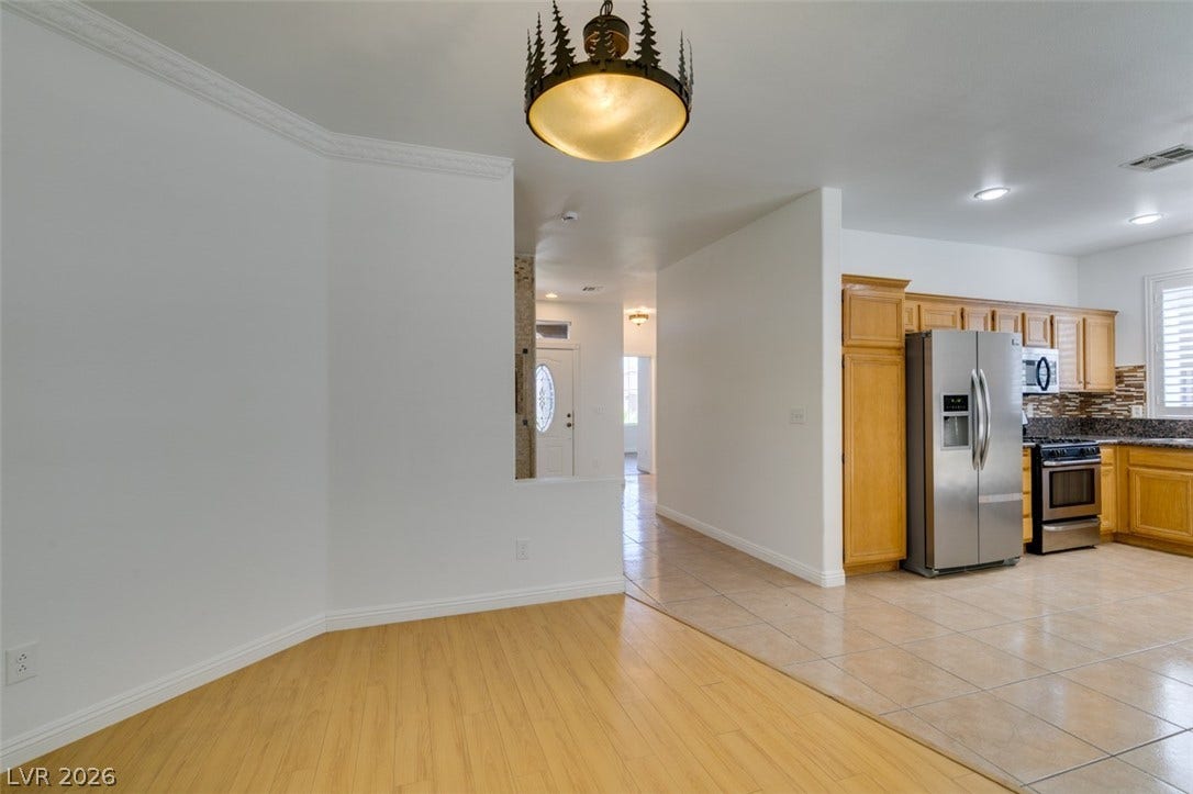 10513 Shanna Trellis Avenue, Las Vegas, NV 89144 Kitchen featuring appliances with stainless steel finishes, light wood-style flooring, and hanging light fixtures