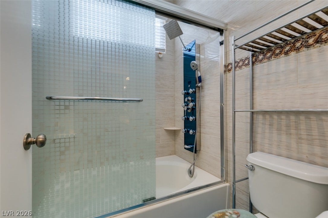 10513 Shanna Trellis Avenue, Las Vegas, NV 89144 Full bathroom featuring bath / shower combo with glass door and toilet