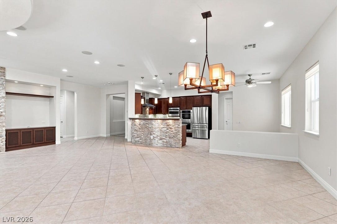 Tiled flooring and a stone-accented breakfast bar define this open-concept layout.
