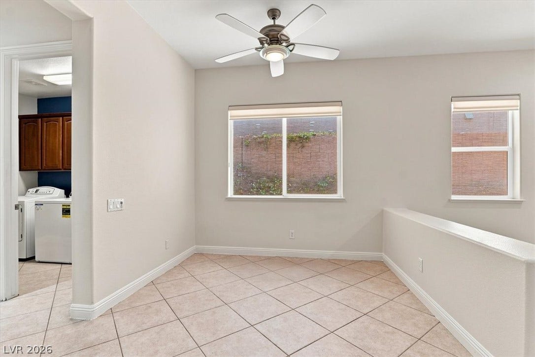 Tiled flooring and neutral walls define this versatile upper-level loft space.