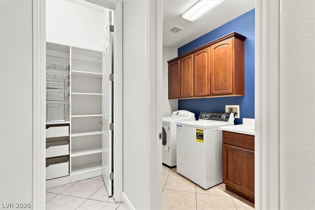 Ample built-in cabinetry and tile flooring elevate this functional household space.