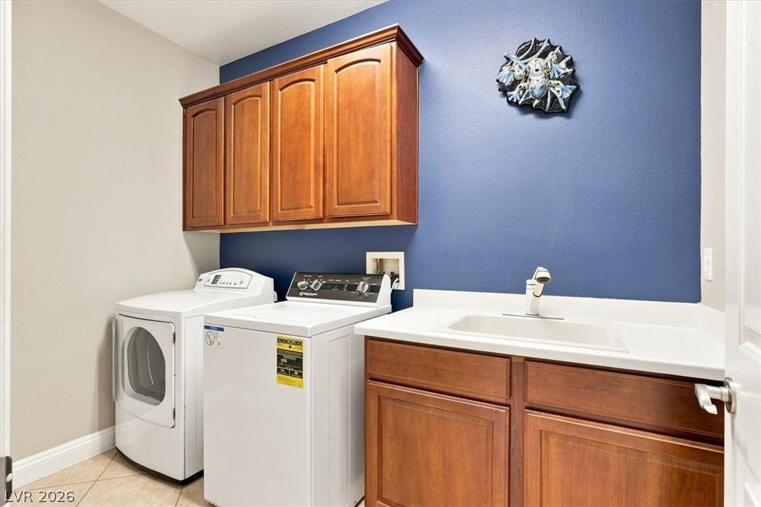 A functional workspace includes wooden cabinets and a convenient wash sink.