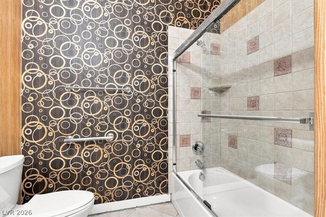 Geometric patterned walls pair with tiled bath surrounds to create a distinctive bathroom design.