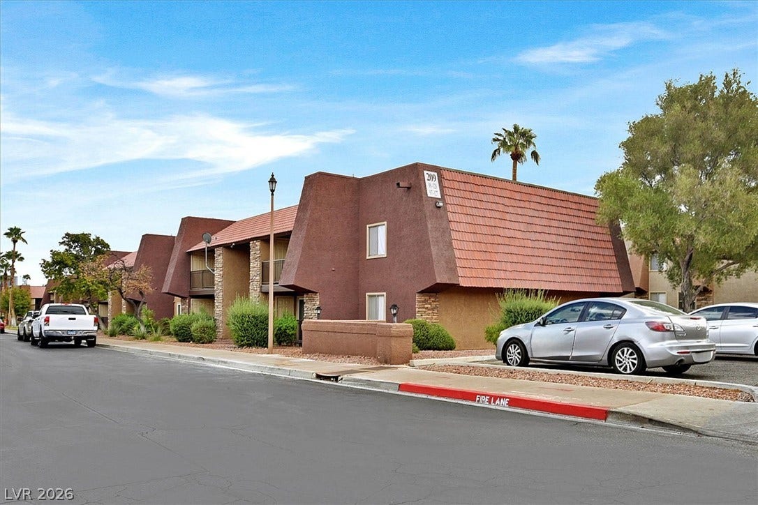 5081 River Glen Drive, #97, Las Vegas, NV 89103 Earthy stucco finishes and mansard roof accents define this building.