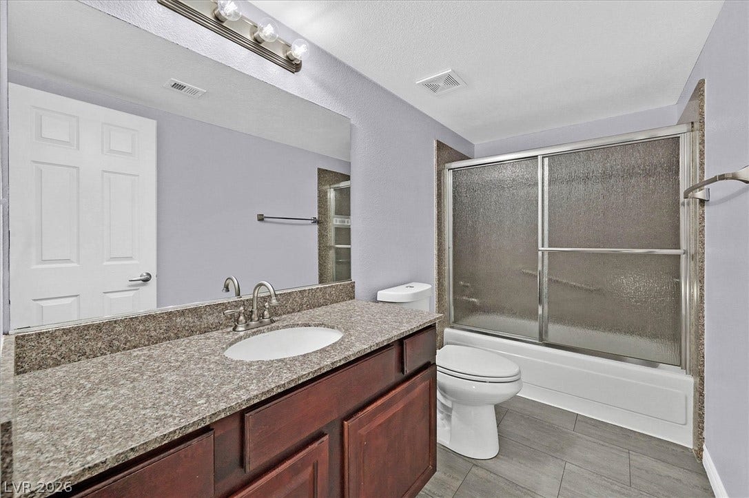 5081 River Glen Drive, #97, Las Vegas, NV 89103 Polished stone counters and durable flooring define this functional bathroom.