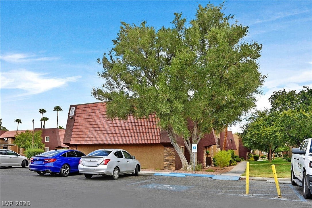 5081 River Glen Drive, #97, Las Vegas, NV 89103 Red mansard tile roofs and stone accents define this classic building exterior.