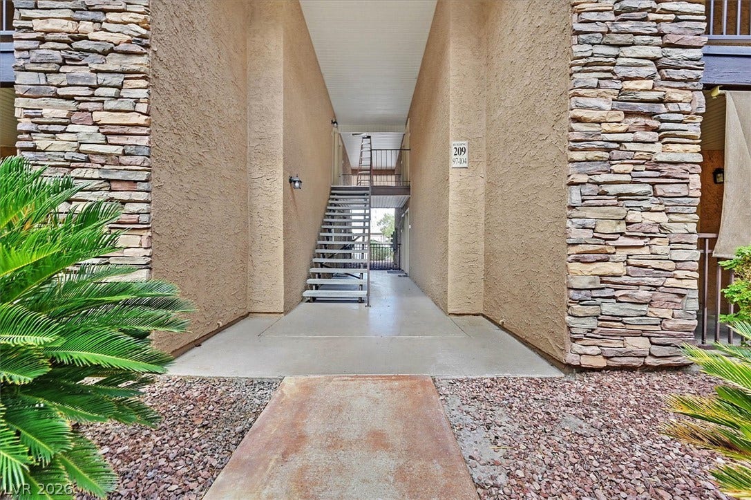 5081 River Glen Drive, #97, Las Vegas, NV 89103 Stacked stone pillars frame the entrance to the breezeway.