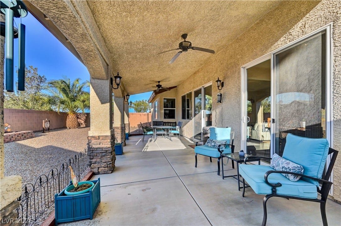 9928 Tradition Creek Avenue, Las Vegas, NV 89149 An inviting covered patio offers ample space for outdoor lounging and dining.