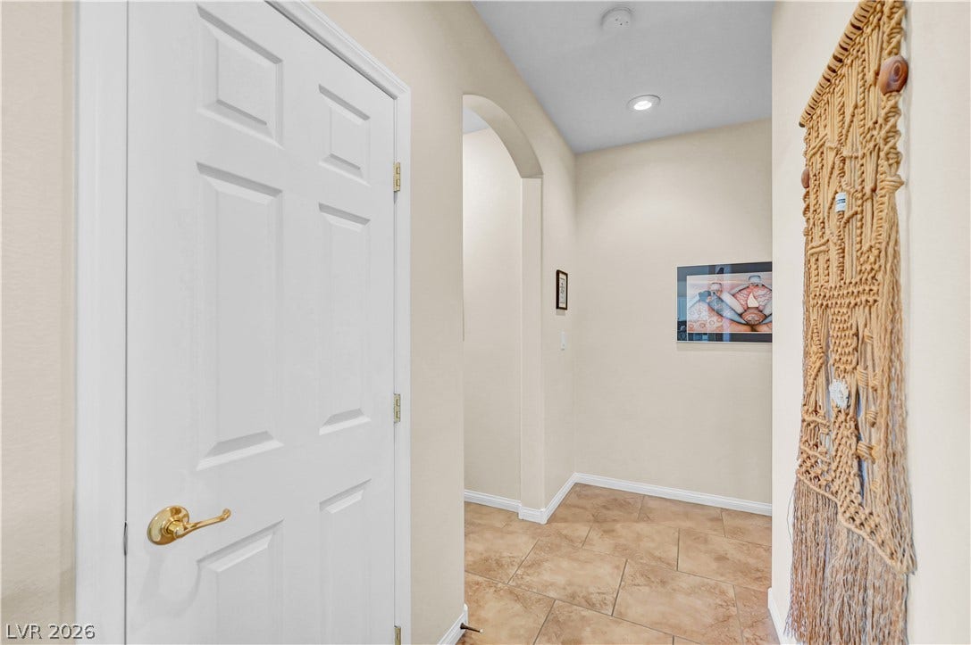 9928 Tradition Creek Avenue, Las Vegas, NV 89149 A well-lit entry hall with tile flooring guides guests into the home's inviting interior.