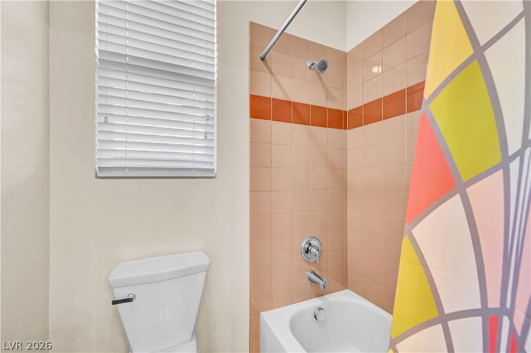 9928 Tradition Creek Avenue, Las Vegas, NV 89149 A well-maintained bathroom with tiled walls and a functional shower-tub combination.