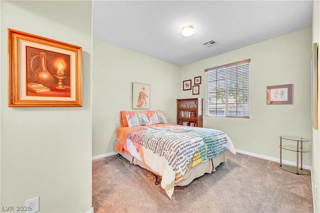 9928 Tradition Creek Avenue, Las Vegas, NV 89149 A quiet retreat, this bedroom offers a restful atmosphere with plush carpeting.