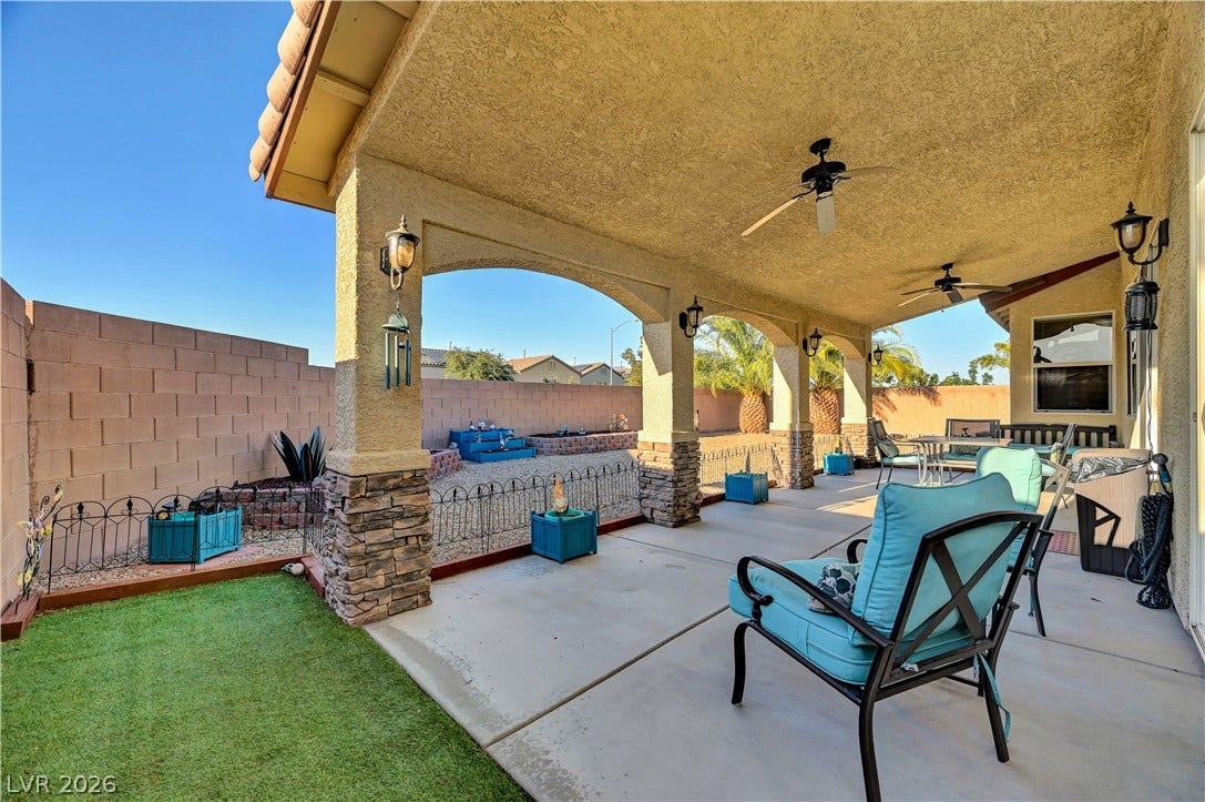 9928 Tradition Creek Avenue, Las Vegas, NV 89149 An inviting covered patio area offers a cool retreat, perfect for alfresco dining and leisure.