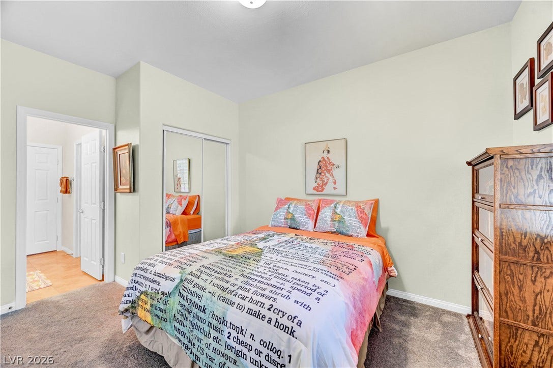 9928 Tradition Creek Avenue, Las Vegas, NV 89149 A cozy bedroom features mirrored closet doors and warm, plush carpeting.