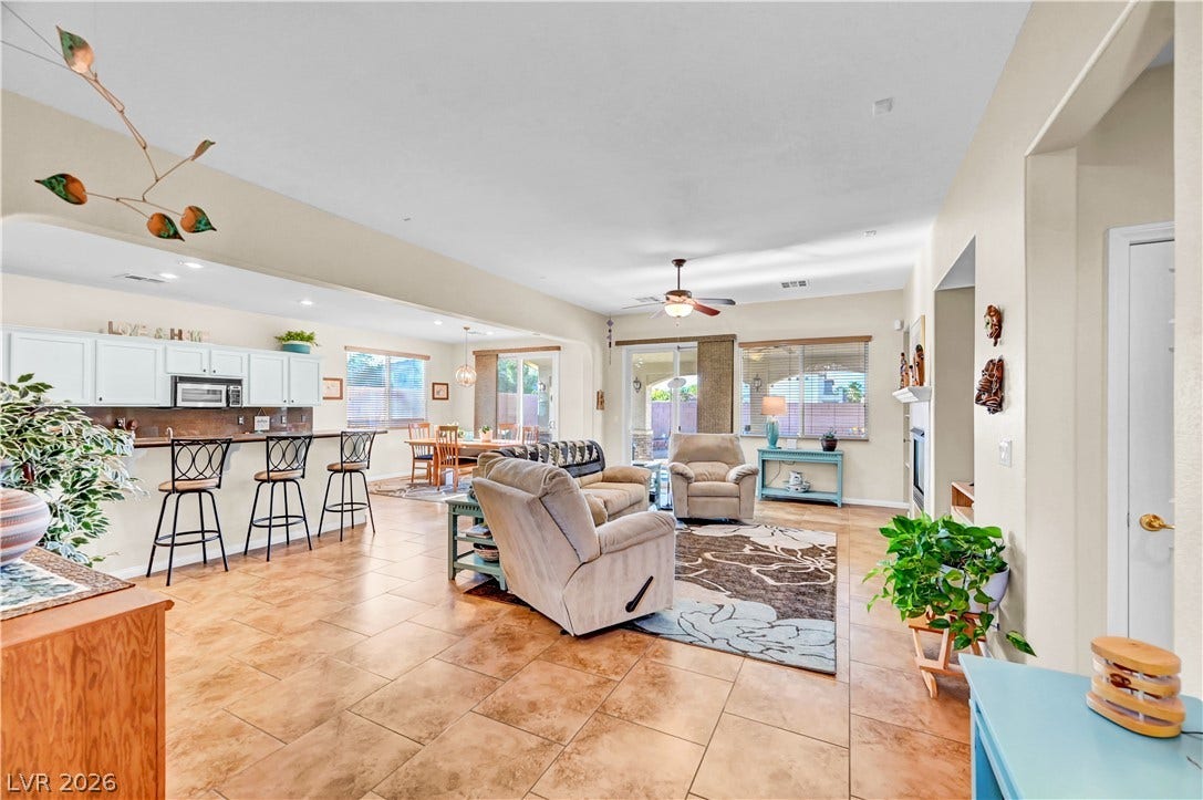 9928 Tradition Creek Avenue, Las Vegas, NV 89149 An open-concept living space with tile flooring seamlessly connects the kitchen and dining areas.