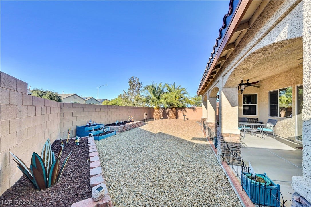 9928 Tradition Creek Avenue, Las Vegas, NV 89149 A spacious, rock-covered private yard offers ample room for outdoor activities and entertaining under the covered patio.
