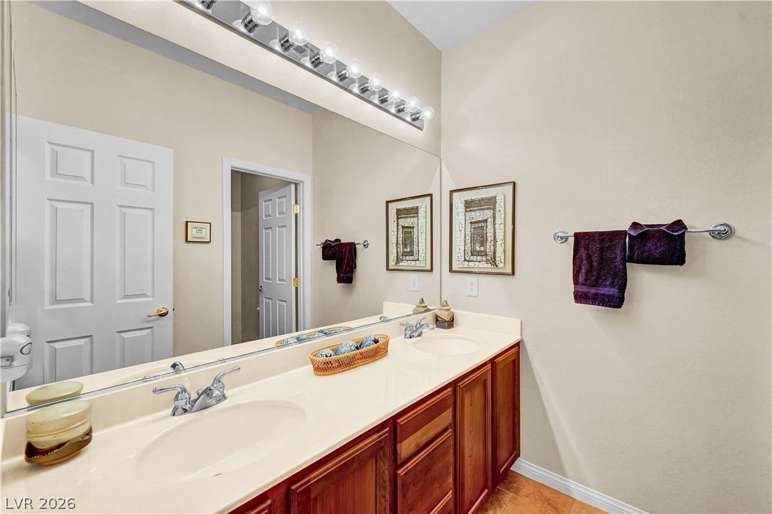9928 Tradition Creek Avenue, Las Vegas, NV 89149 Double vanity with ample counter space creates a functional and inviting bathroom retreat.