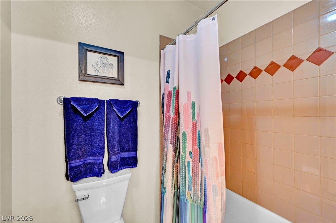 9928 Tradition Creek Avenue, Las Vegas, NV 89149 A well-maintained bathroom with tiled walls and a functional shower area.