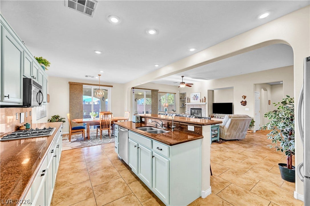 9928 Tradition Creek Avenue, Las Vegas, NV 89149 An open-concept living area features a well-appointed kitchen with an island overlooking the dining and living spaces.