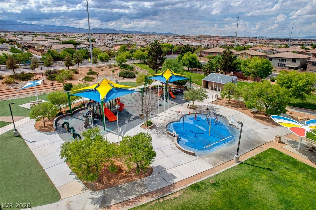 9928 Tradition Creek Avenue, Las Vegas, NV 89149 A vibrant playground and splash pad invite outdoor recreation within a community park.