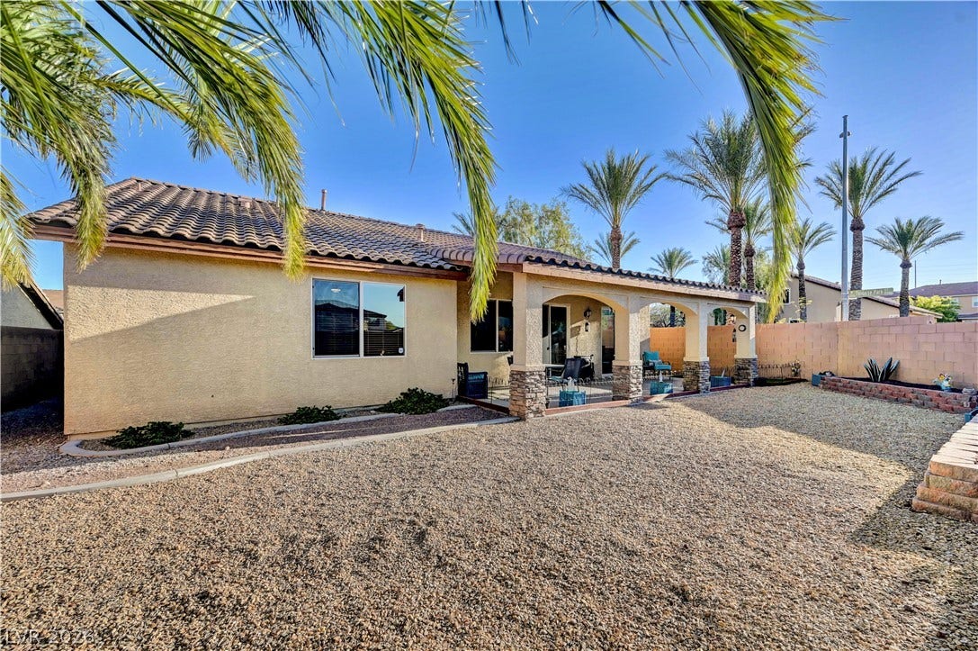 9928 Tradition Creek Avenue, Las Vegas, NV 89149 A spacious, rock-covered backyard provides a low-maintenance oasis with a covered patio perfect for outdoor living.