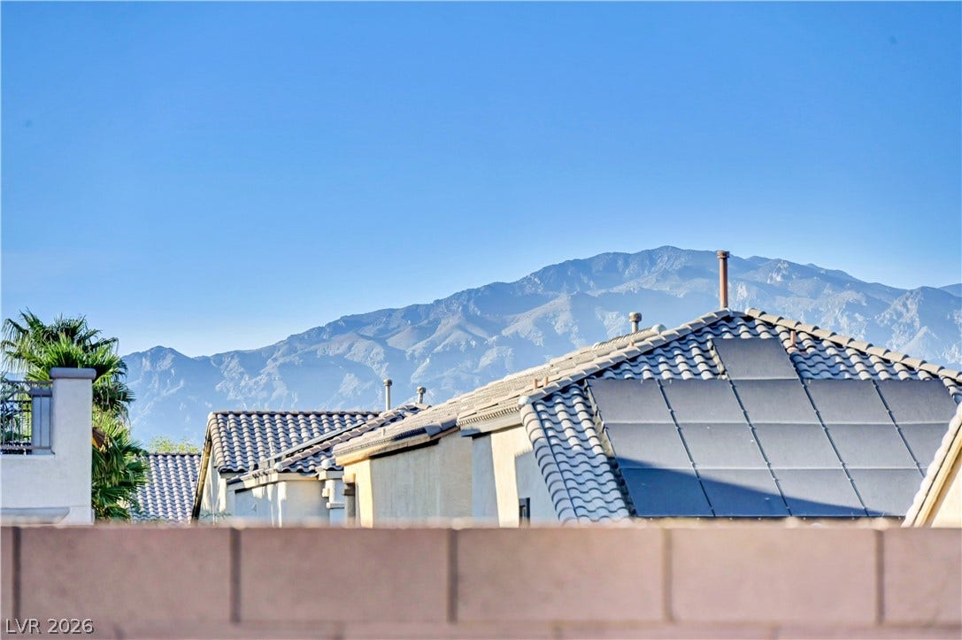9928 Tradition Creek Avenue, Las Vegas, NV 89149 Panoramic mountain views complement this home's tiled roof and modern solar panel system.