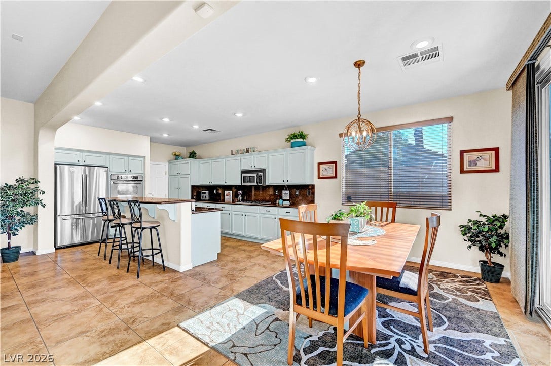 9928 Tradition Creek Avenue, Las Vegas, NV 89149 An open-concept kitchen and dining area features abundant cabinetry and a practical island for daily living.