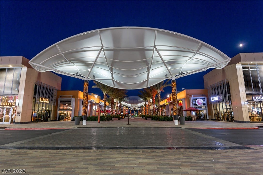 An inviting pedestrian walkway illuminates a vibrant community hub.