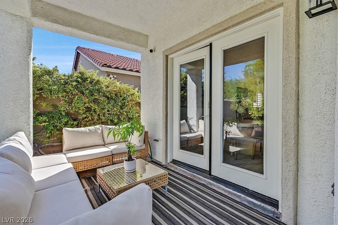 An inviting covered patio offers a comfortable outdoor living space, ideal for tranquil relaxation.