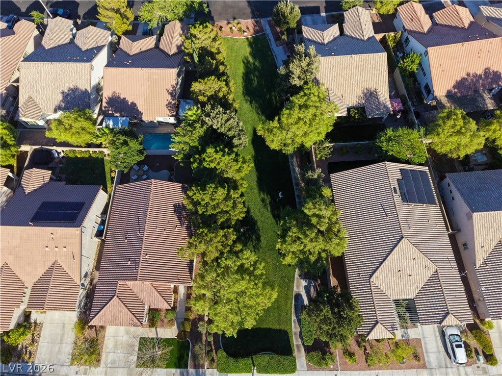 An aerial perspective reveals a vibrant neighborhood with well-maintained green spaces and residential roofs.