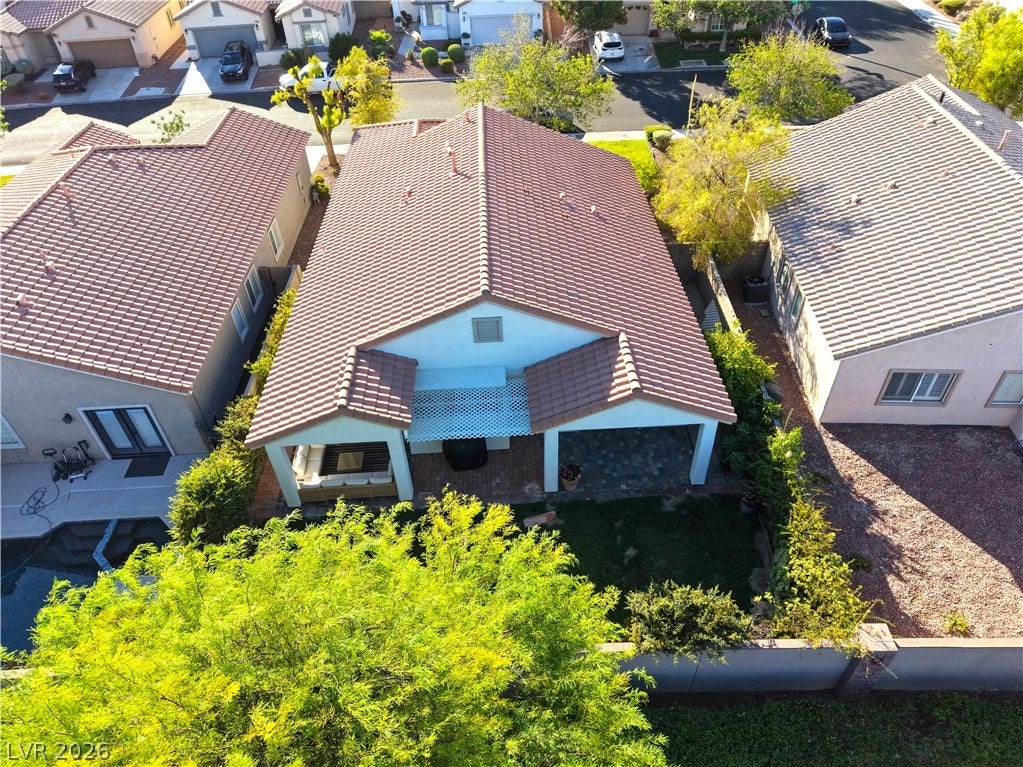 An aerial perspective reveals a charming home featuring a covered patio, perfect for outdoor relaxation.