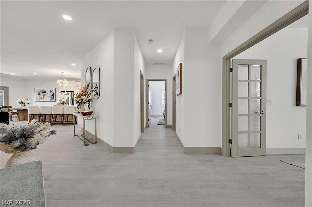 An inviting open-concept layout features continuous flooring and abundant overhead illumination.