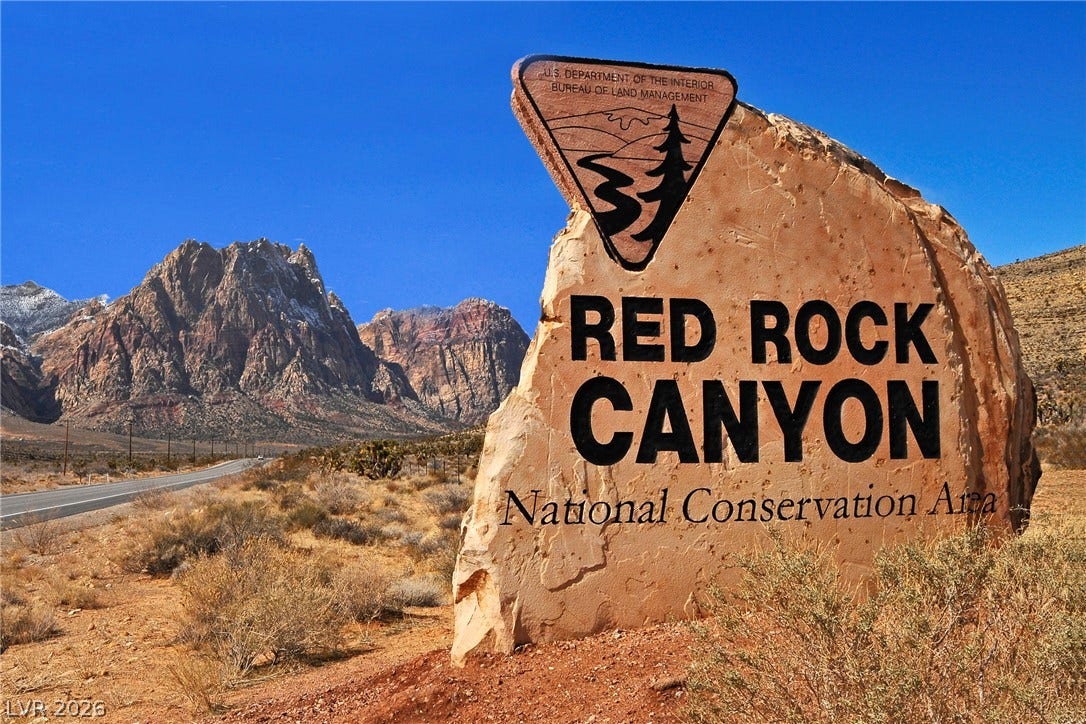 Red Rock Canyon National Conservation Area: a scenic landscape with majestic mountains and a clear desert sky.