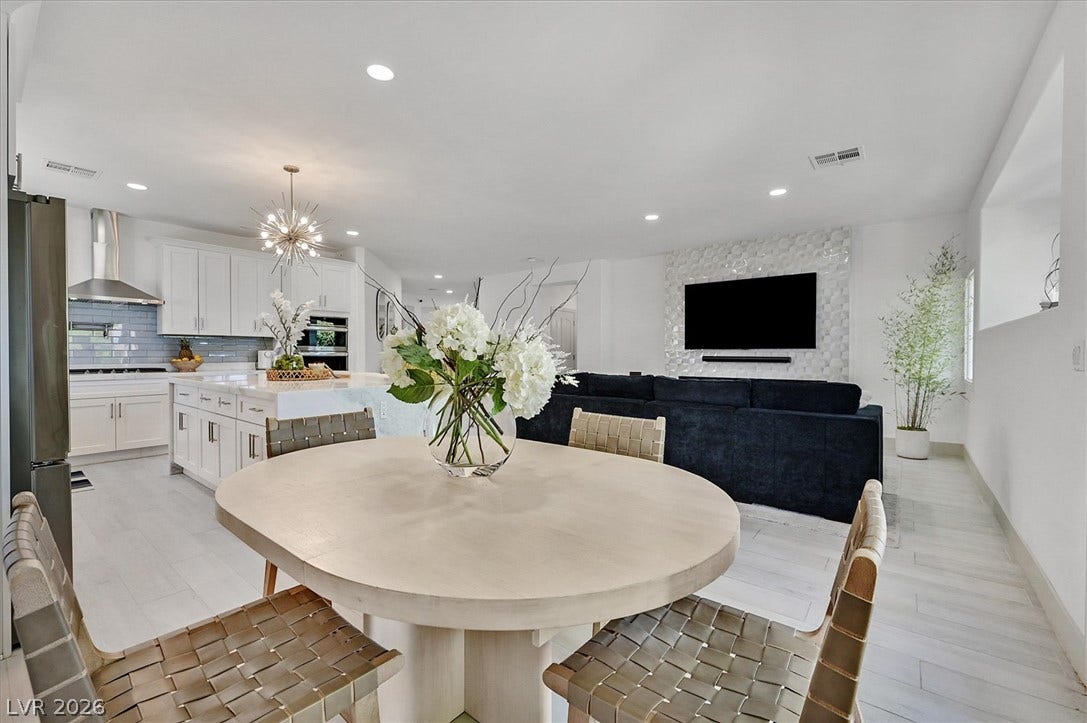 An open-concept living area features a bright, modern kitchen with an island, flowing into a spacious living room.