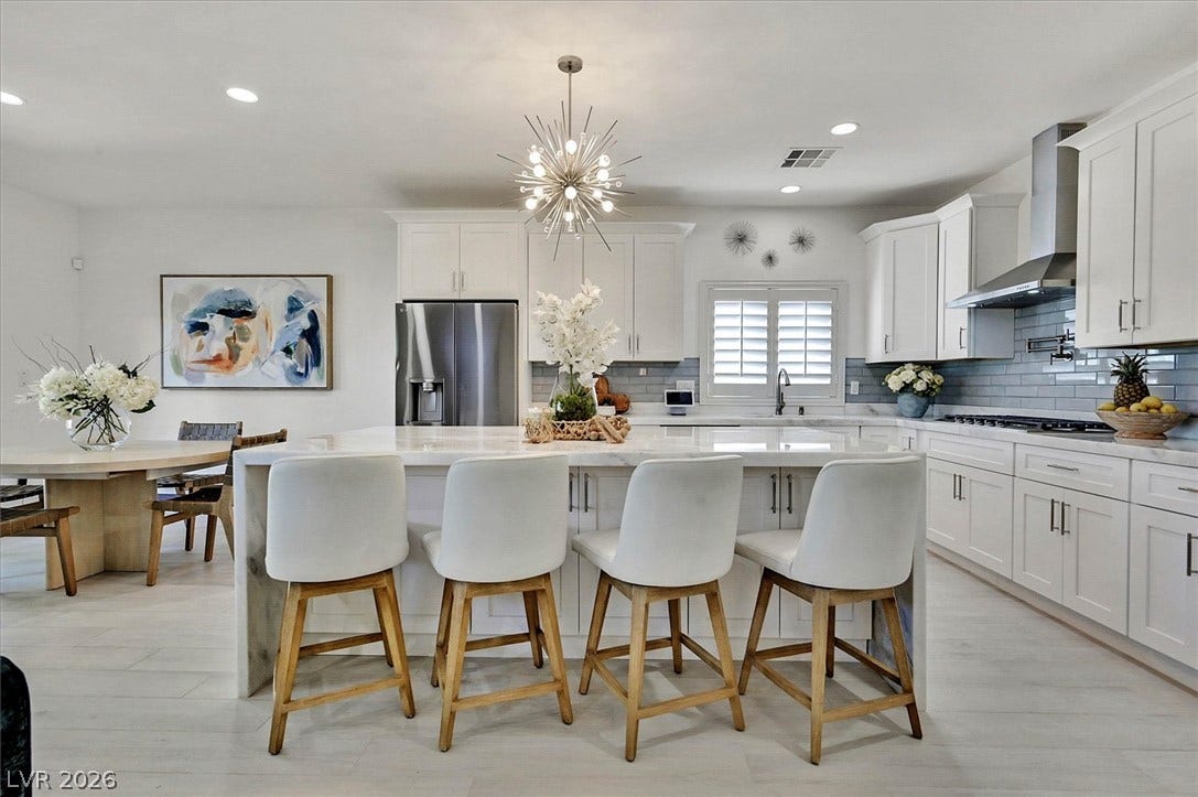 Culinary excellence meets casual dining in this well-appointed kitchen featuring a substantial island and gleaming finishes.