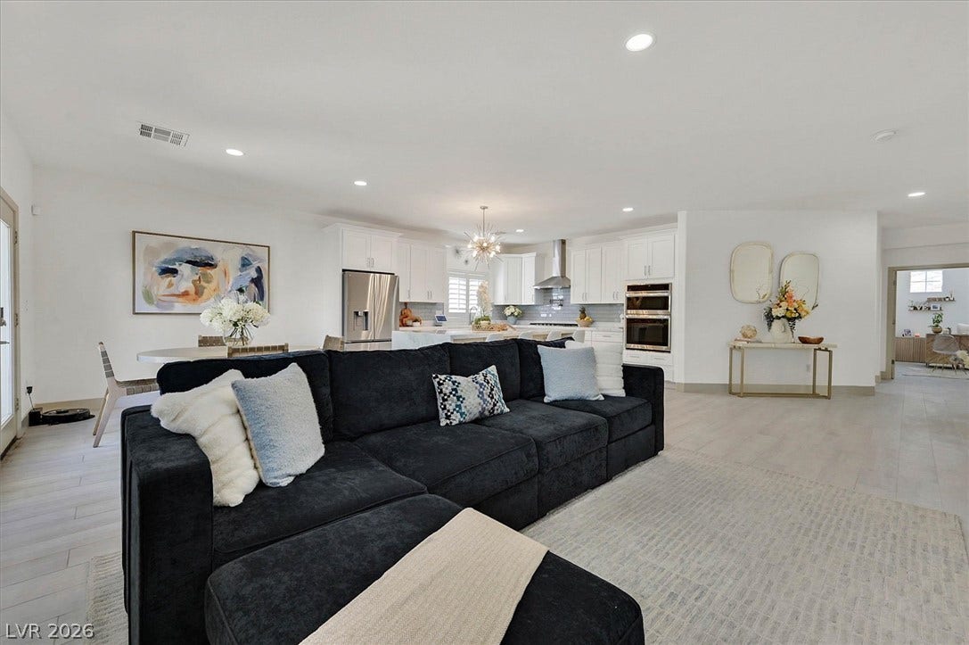 An open concept floor plan seamlessly connects the living area, dining room, and a well-appointed kitchen.