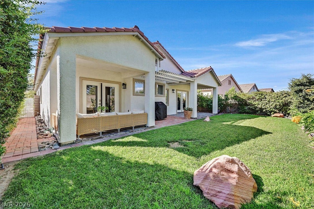 A verdant lawn wraps around the property, with lemon and fig trees providing ample space for outdoor enjoyment.