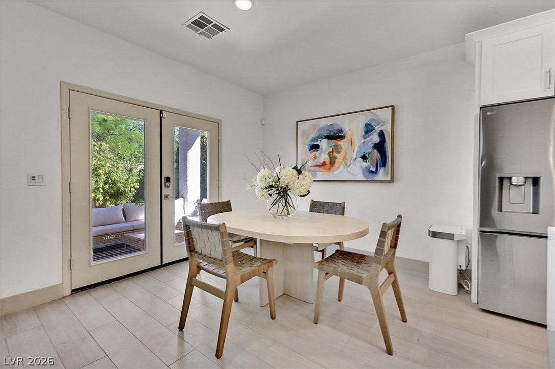 Patio access with French doors extends the bright dining area, offering an effortless indoor-outdoor flow.