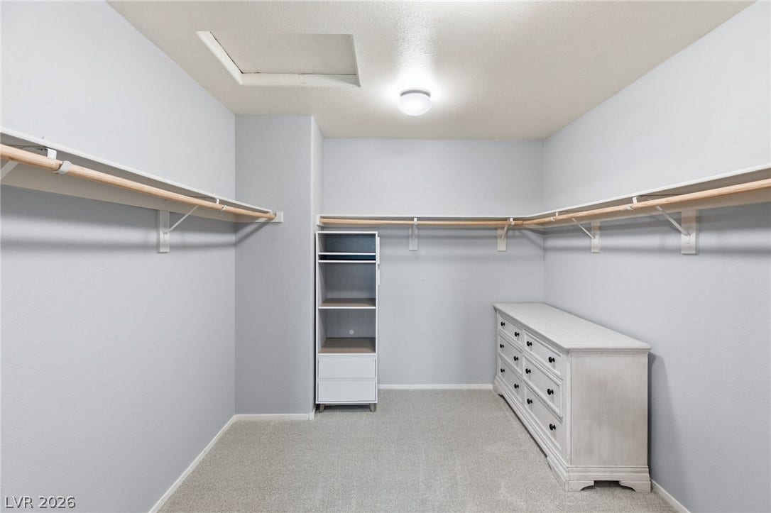 Ample hanging space and storage shelving define this well-appointed walk-in closet.