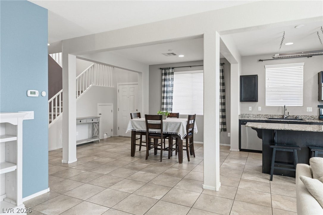 An open floorplan seamlessly connects the dining area, kitchen, and living space.
